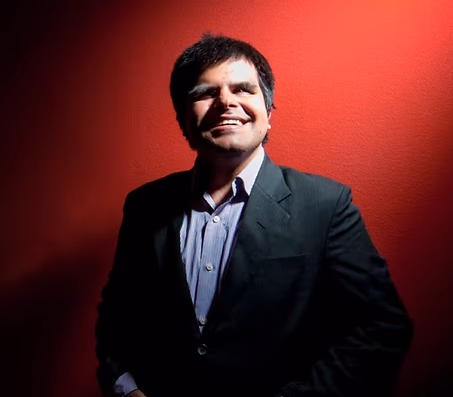 A laughing Network member in a blazer