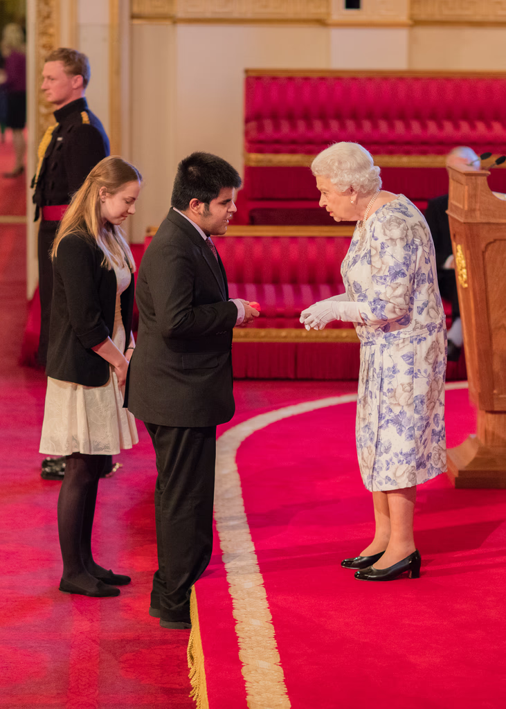 Kartik Sawhney being presented with the Queen's Young Leader Award by Queen Elizabeth II