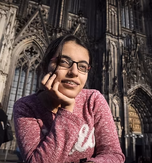 A young Network member in front of a cathedral